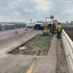 Concrete crew fixing road patch on overpass in Colorado
