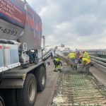 On-Demand Concrete truck pouring site mixed concrete to repair overpass road